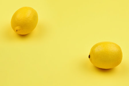 Lemon isolated on yellow background. Space for test or design.の写真素材
