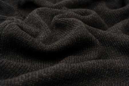 Dark gray sweater texture as a background. Knitted pattern. Top view.の写真素材