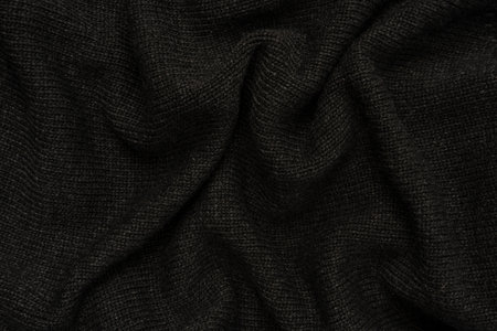 Dark gray sweater texture as a background. Knitted pattern. Top view.の写真素材