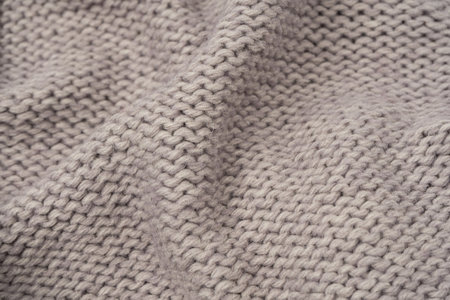Gray wool sweater texture as a background. Top view.