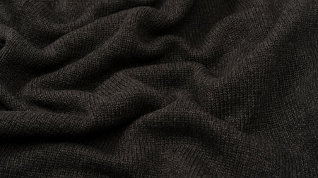 Dark gray sweater texture as a background. Knitted pattern. Top view.の写真素材