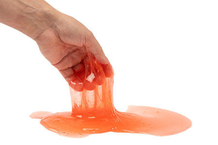 Red slime in man hand isolated on white. Top view.の写真素材