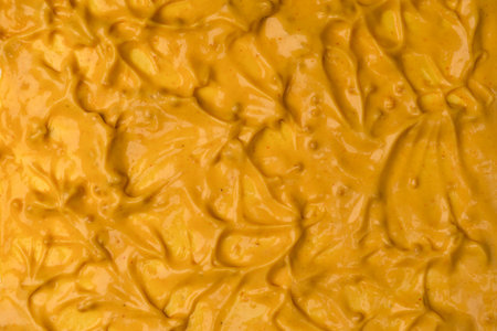 Yellow sauce splashes as a background. Top view.の写真素材