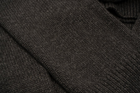 Dark gray sweater texture as a background. Knitted pattern. Top view.の写真素材