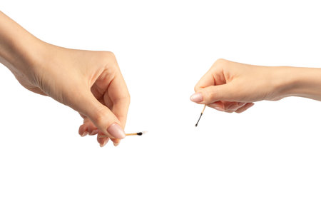 Lit match in a woman hand isolated on a white background. Copy space.