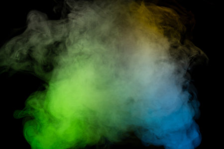 Blue and yellow steam on a black background.の写真素材
