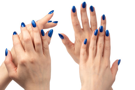 Hand of a woman with blue nails isolated on a white background.の写真素材