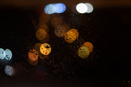 Blurred background with raindrops and lights.