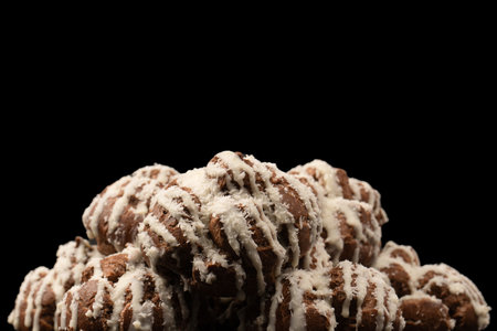 Profiteroles with coconut cream on a black background.
