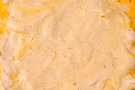 Yellow sauce splashes as a background. Top view.の写真素材
