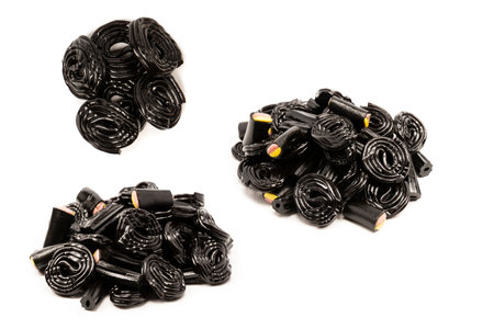 Jelly anise candy isolated on a white background. Black jelly candies. Top view. Delicious gelatin...
