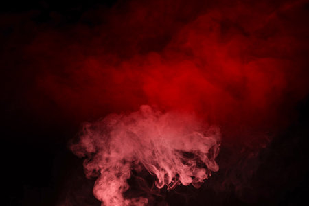 Yellow and pink steam on a black background. Copy space.の写真素材