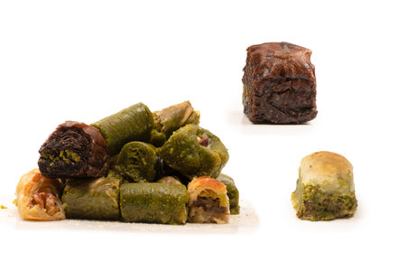 Turkish pistachio baklava isolated on a white background. A variety of turkish sweet baklava. Walnut baklava.の写真素材