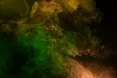 Yellow and pink steam on a black background. Copy space.