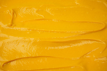 Yellow sauce splashes as a background. Top view.