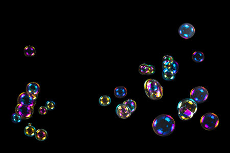 Soap bubbles isolated on a black background. Copy space.