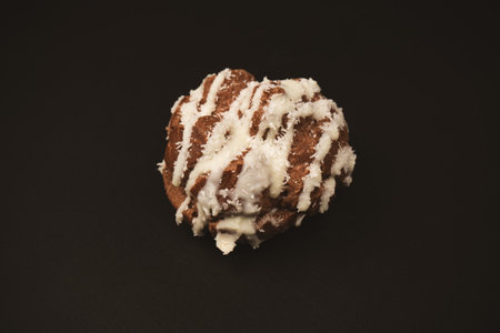 Profiteroles with coconut cream on a black background.