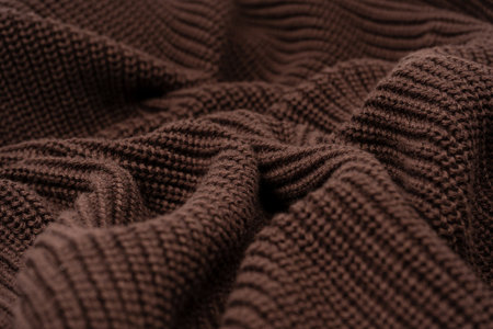 Brown sweater texture as a background. Top view.