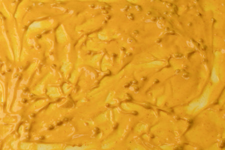Yellow sauce splashes as a background. Top view.