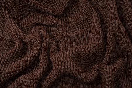 Brown sweater texture as a background. Top view.