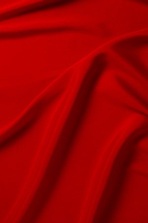 Red silk or satin luxury fabric texture can use as abstract background. Top view.の写真素材