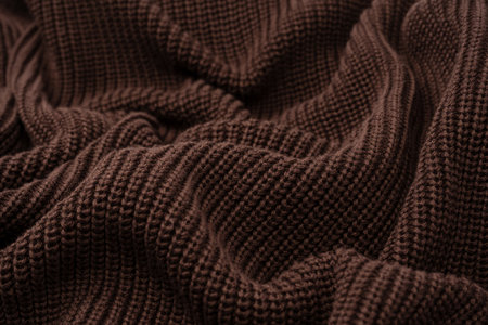 Brown sweater texture as a background. Top view.