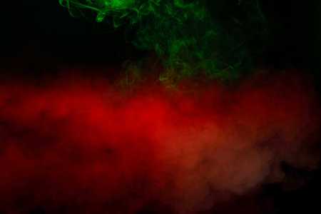 Green and pink steam on a black background. Copy space.の写真素材