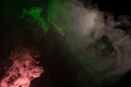 Green and pink steam on a black background. Copy space.の写真素材