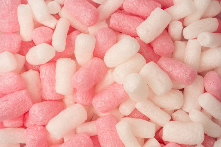 Pink and white box filler as a background. Top view.