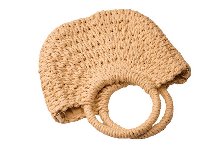 A beige straw bag isolated on a white background.の写真素材