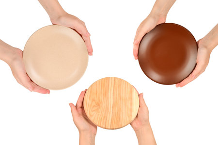 Empty plate in woman hands isolated on white background.の写真素材