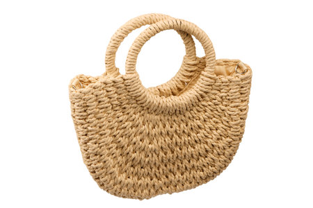 A beige straw bag isolated on a white background.の写真素材