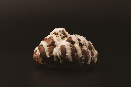 Profiteroles with coconut cream on a black background.の写真素材
