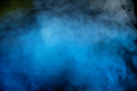 Blue and yellow steam on a black background. copyspace.の写真素材