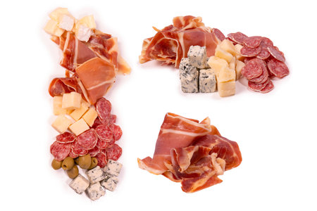 A plate with snacks for wine. Cheese, olives, salami, jamon isolated on a white backgrund.の写真素材