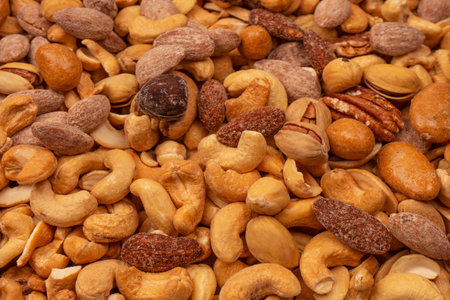 Mix of tasty salty nuts. A group of almonds, pistachios, walnuts, macadamia, cashews.
