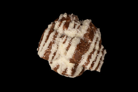 Profiteroles with coconut cream on a black background.