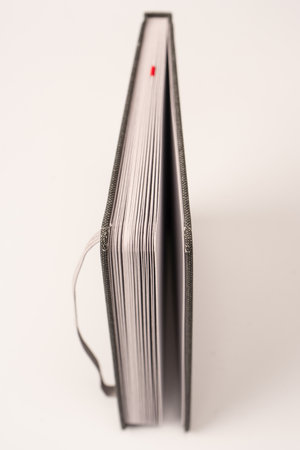 Gray notebook with blank pages isolated on a white background. Top view.