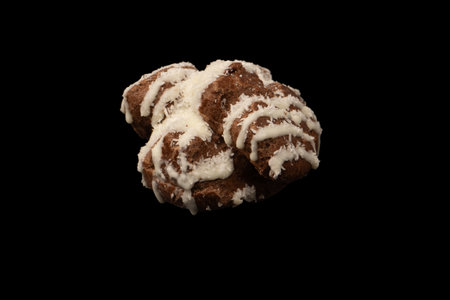 Profiteroles with coconut cream on a black background.