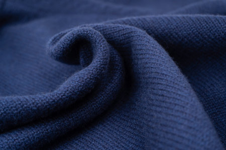 Navy blue merino wool sweater texture as background. Top view.