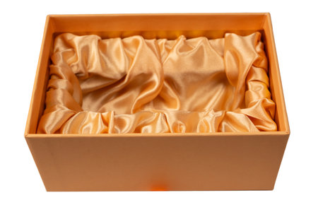 Orange empty gift box covered with orange satin fabric isolated on a white background. Top view.の写真素材