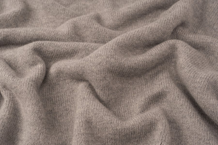 Soft gray merino wool sweater texture as a background. Top view.