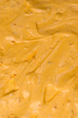 Yellow sauce splashes as a background. Top view.の写真素材