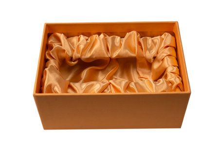 Orange empty gift box covered with orange satin fabric isolated on a white background. Top view.