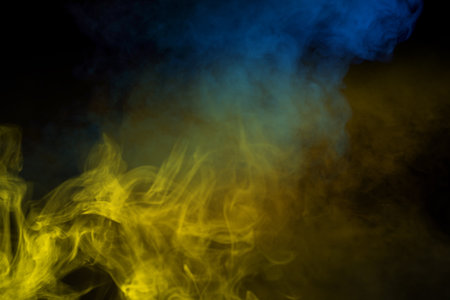 Yellow steam on a black background. Copy space.の写真素材