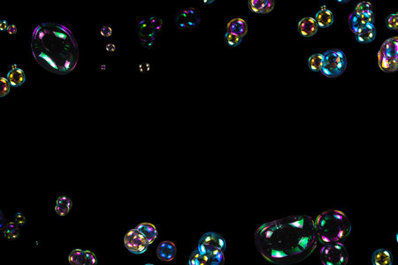 Soap bubbles isolated on a black background. Copy space.