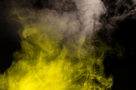 Yellow steam on a black background. Copy space.の写真素材