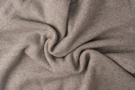 Soft gray merino wool sweater texture as a background. Top view.