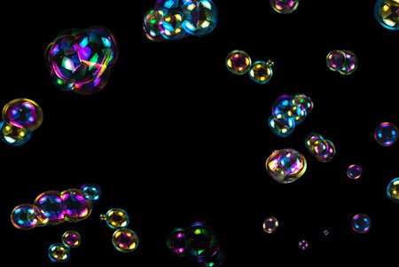 Soap bubbles isolated on a black background. Copy space.