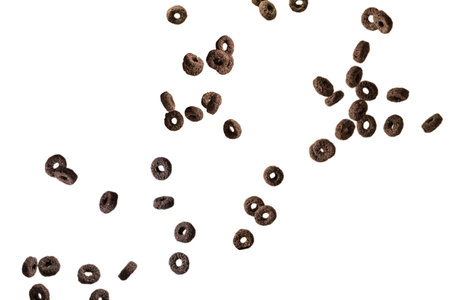 Chocolate rings cereal spill out into a bowl. Breakfast. Isolated on a white background.の写真素材